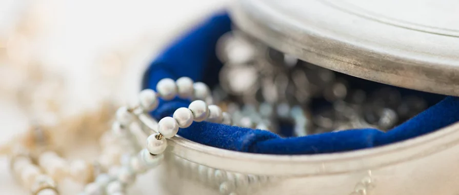 close-up of silver jewelry box with pearls