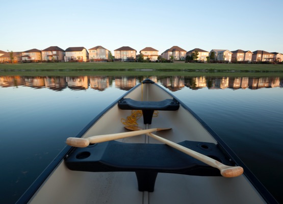 New housing area for Winnipeg, Manitoba. Low light, hand held image with a canoe.