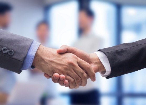 close up two businessman hand shake together for agreement successful on blur group of businesspeople talking in meeting room , achievement concept