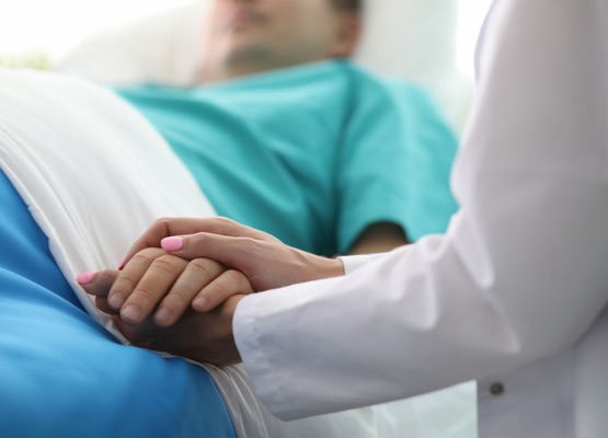 Female doctor hands hold male arm in medical hospital closeup. Medicine work drama concept