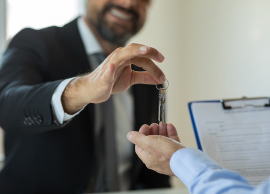 Realtor hand giving keys to new house owner