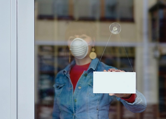 woman in closed shop with mask