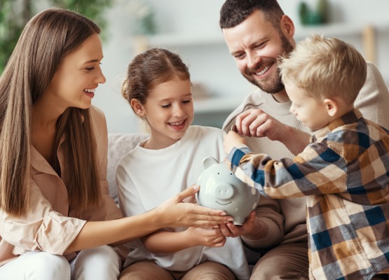 financial planning happy family mother father and children with piggy Bank at home