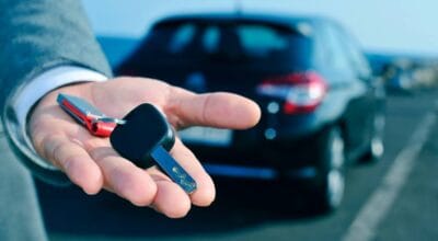 man holding a rental car key
