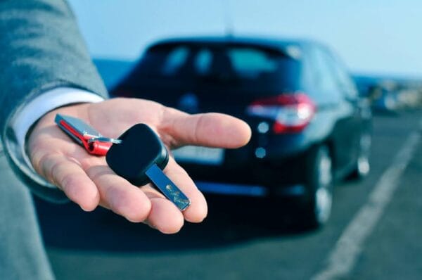 man holding a rental car key