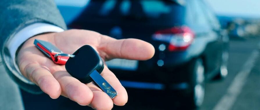 man holding a rental car key